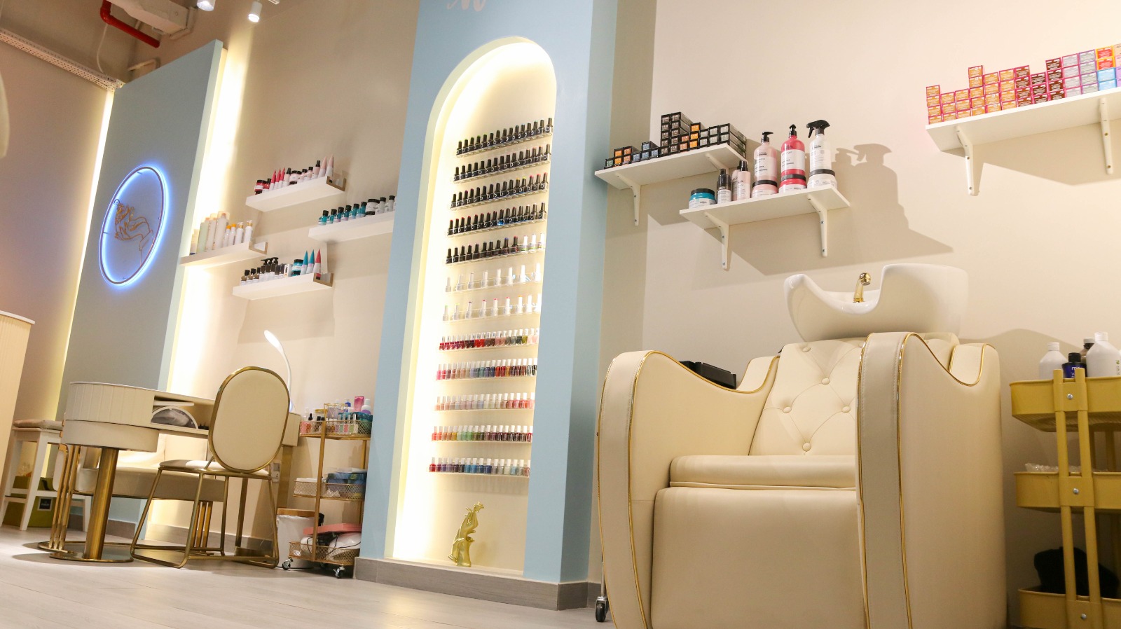 Nail polish wall display and wash basin at Qareat Al Fenjan